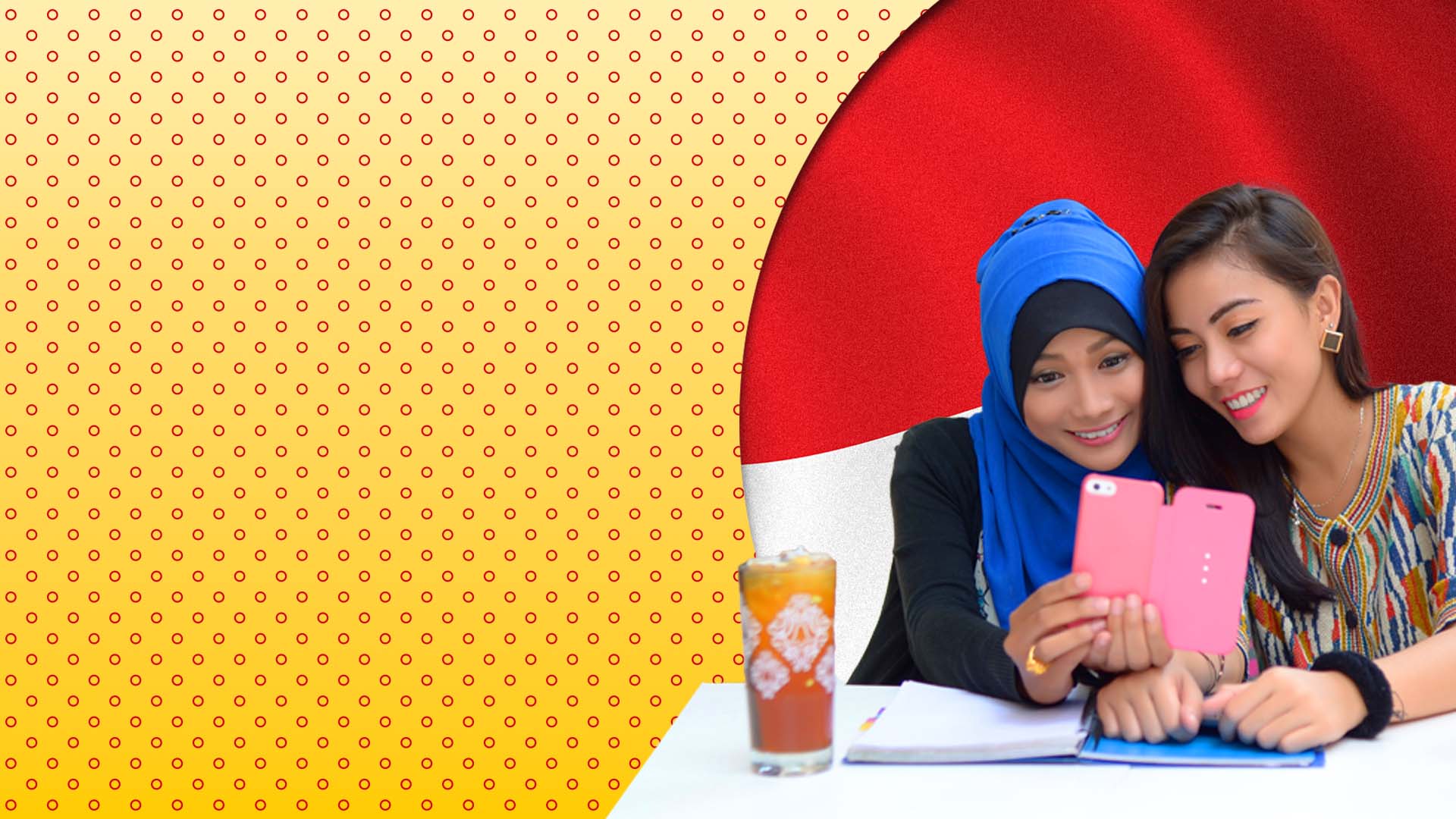 two women smiling at mobile phone screen