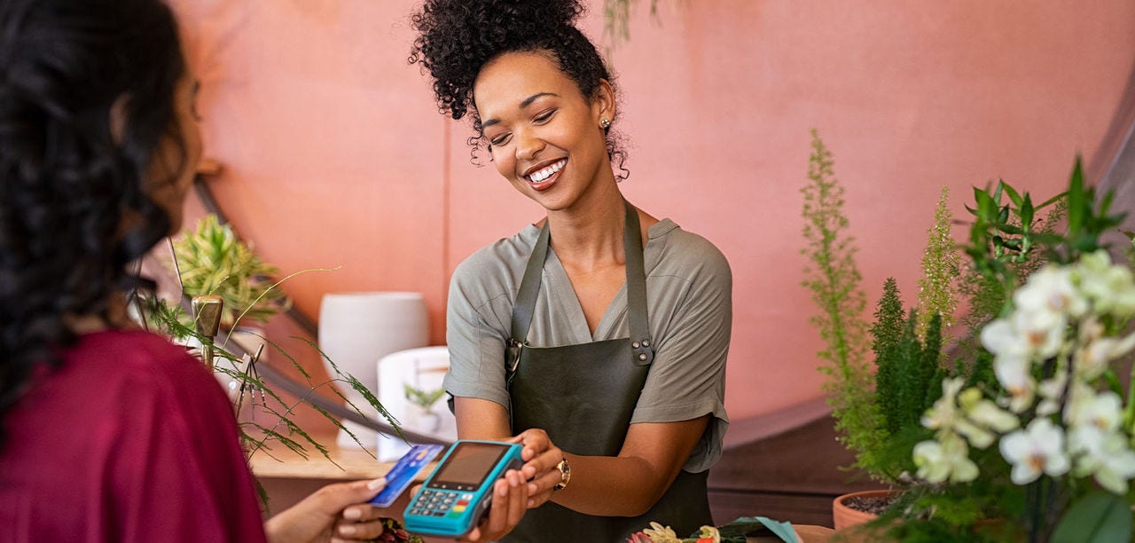 woman holding out payment device