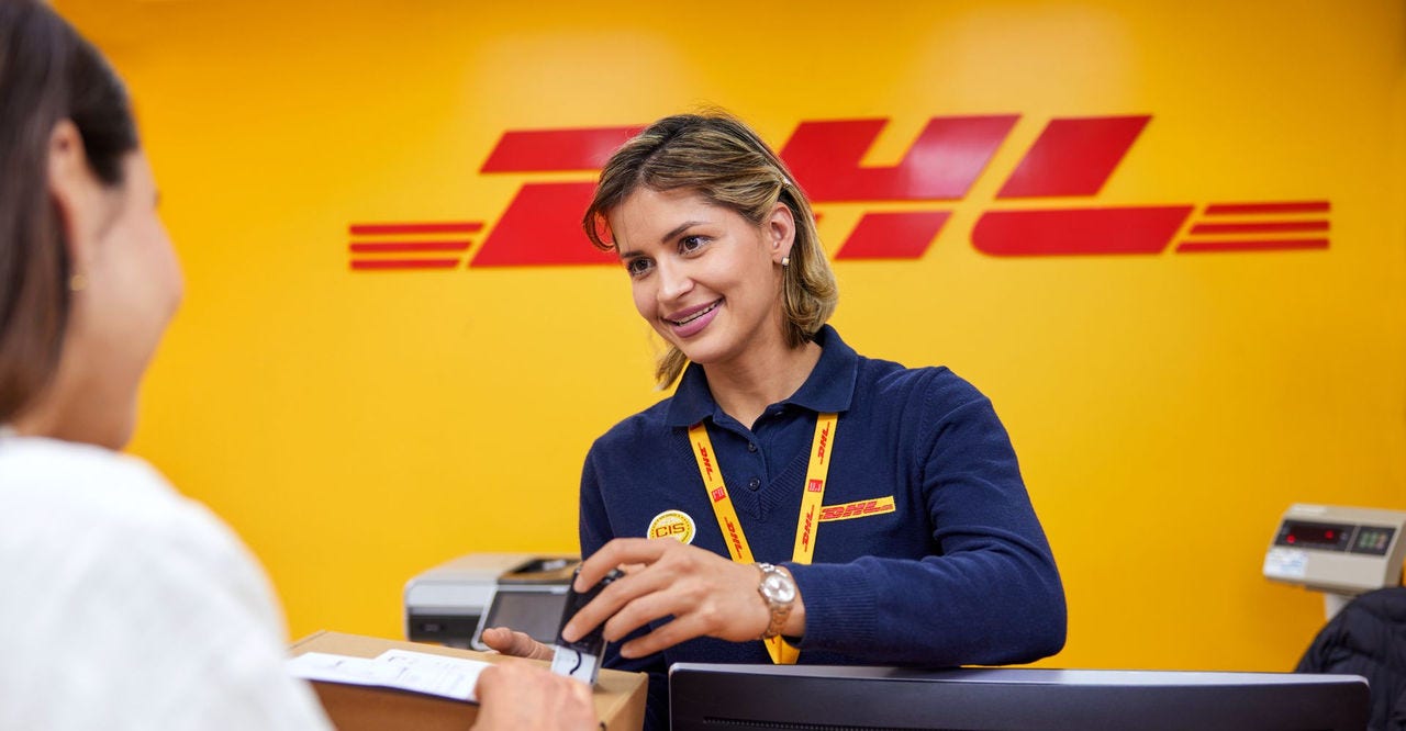 dhl express staff helping a business owner to send a parcel from vietnam to the uk