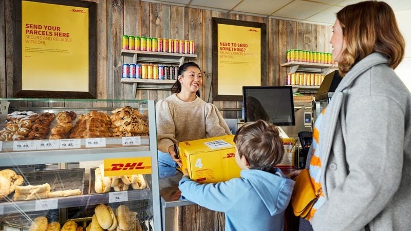 Lady and son at a DHL Service point to send an international parcel