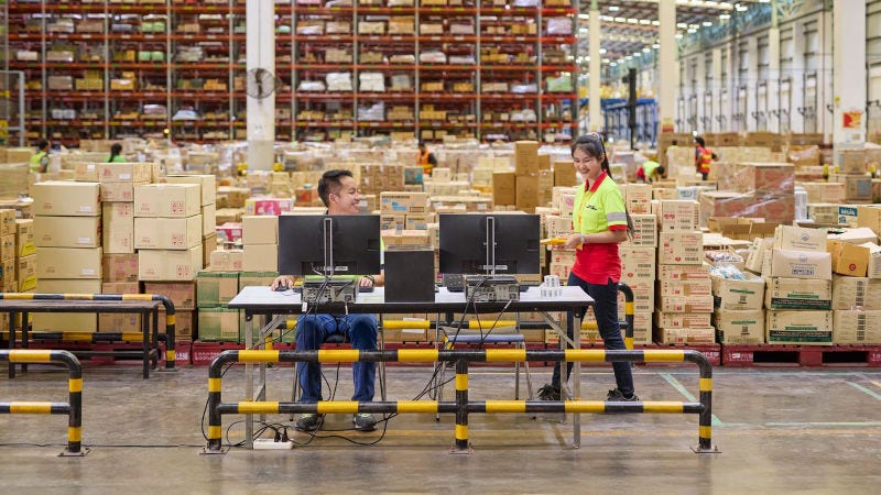a male and female DHL staff working in warehouse
