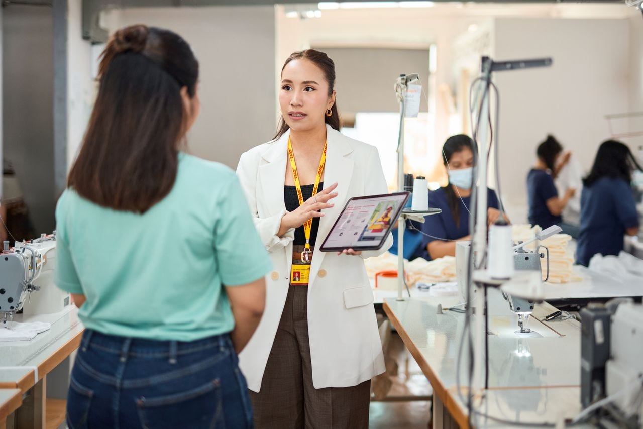 female dhl employee explaining import duty to a business owner