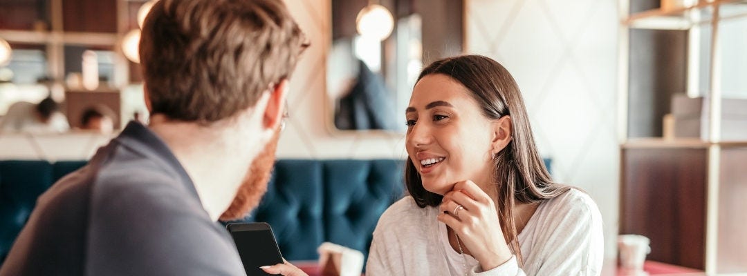 Two people talking in cozy cafe setting