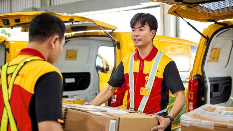 dhl express employees preparing parcels for delivery after customs clearance