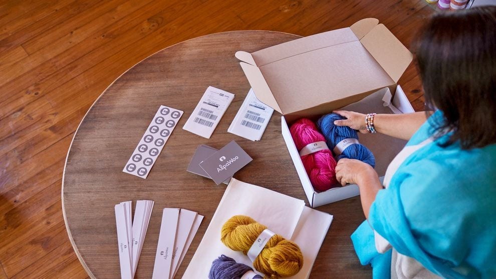 a business owner preparing woolen products to deliver overseas