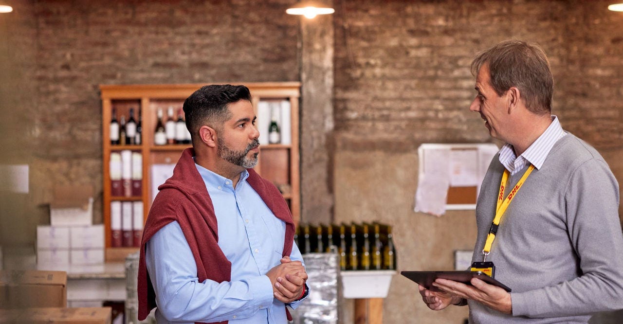 business owner discussing international shipping options to the US with dhl express employee