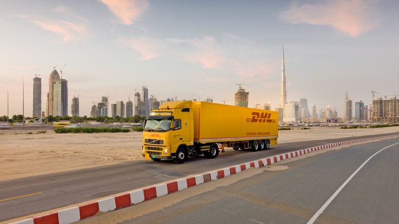 a large DHL truck transporting heavy shipments across the country 