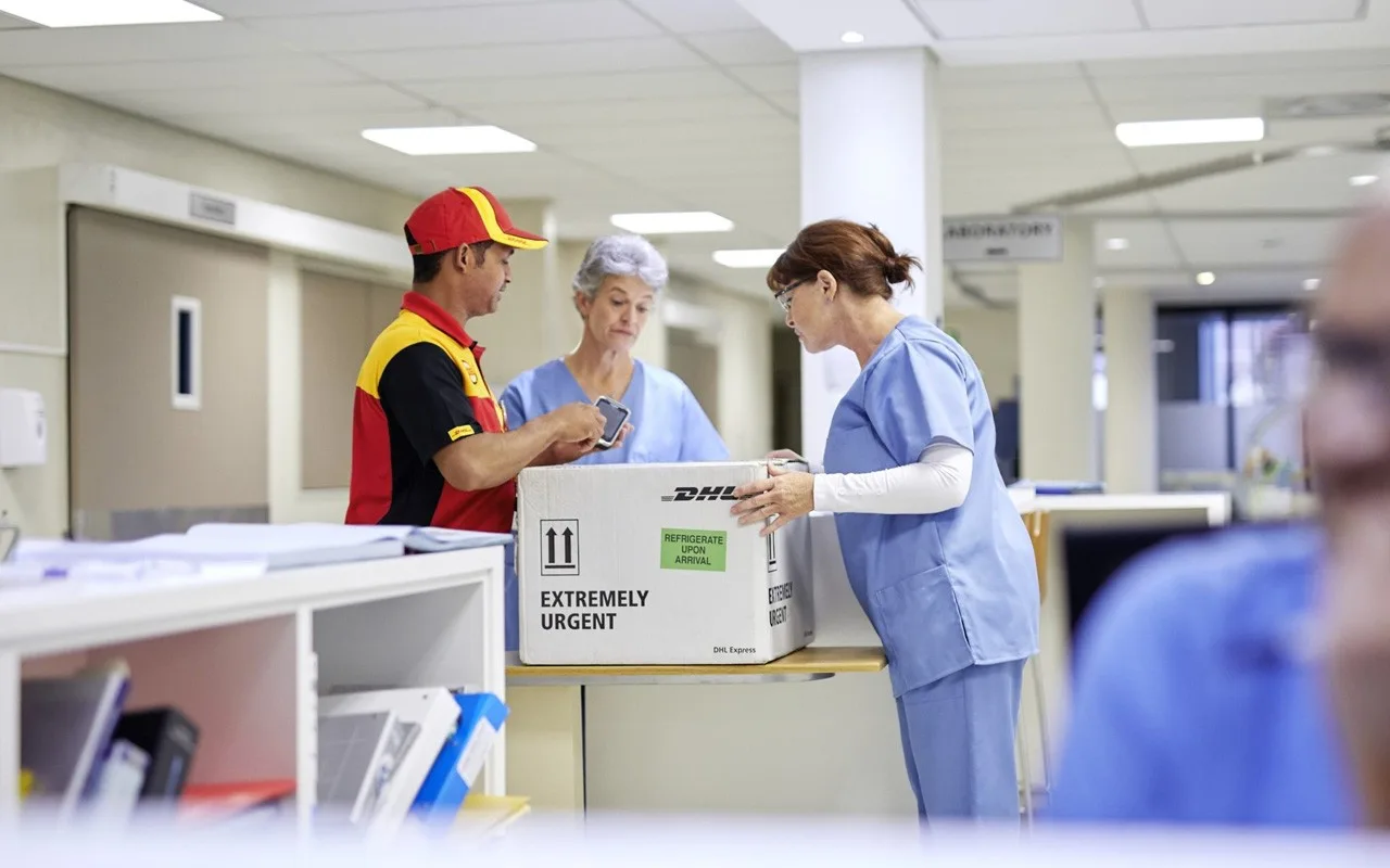 dhl express wmx courier completing urgent medicine delivery