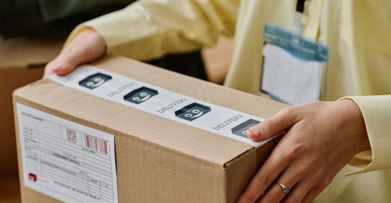 woman handling an e-commerce box with export documents attached