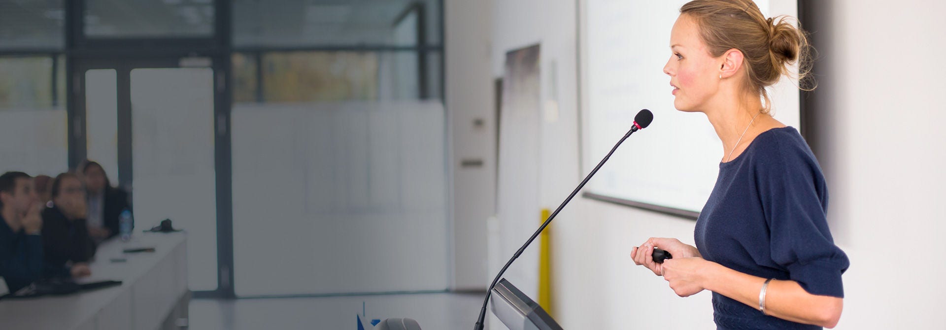 woman speaking into a microphone