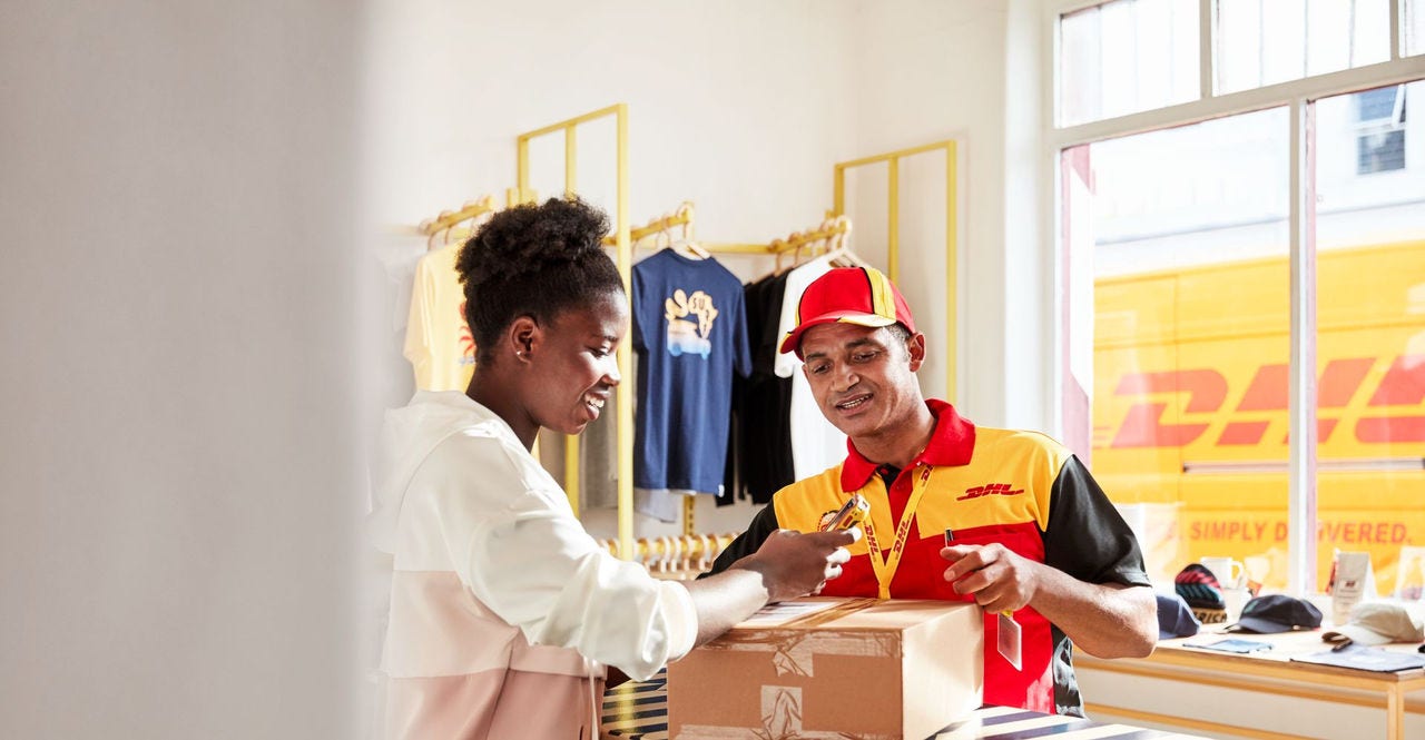 dhl express courier picking up a package of made-to-measure clothing