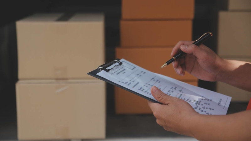 indian business owner filling up an international waybill