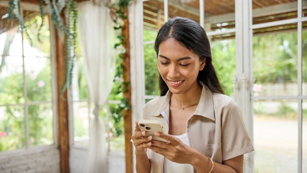 A female customer looks at her smartphone.