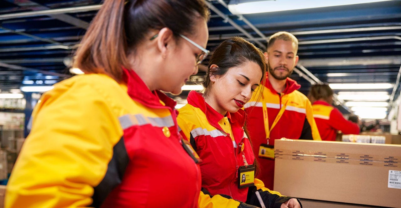 dhl employees helping with anti-static packaging for semiconductors