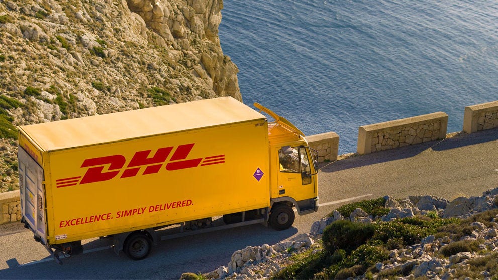 a DHL Express truck carrying a shipment of large items en route to its delivery location