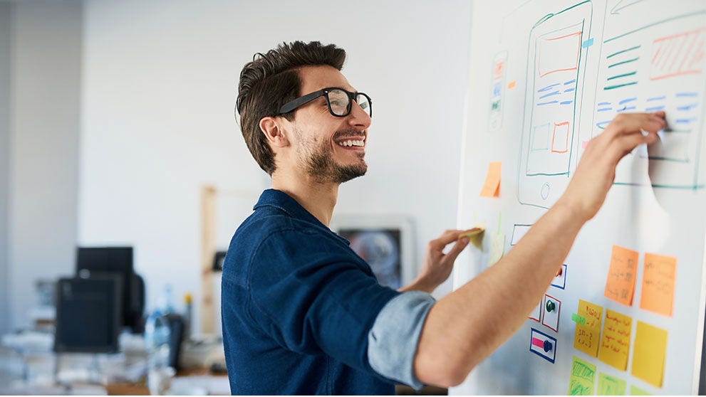 man writing on whiteboard