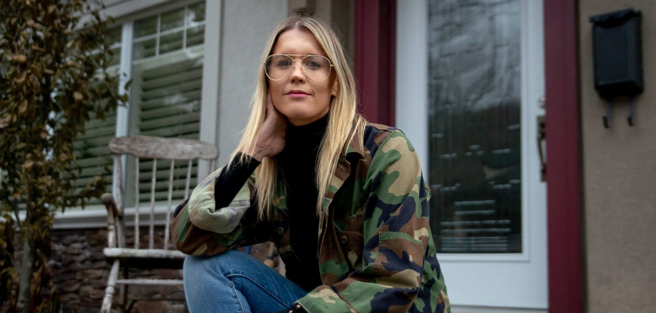 Emily O'Brien, founder of the popcorn company Comeback Snacks, poses on front porch steps
