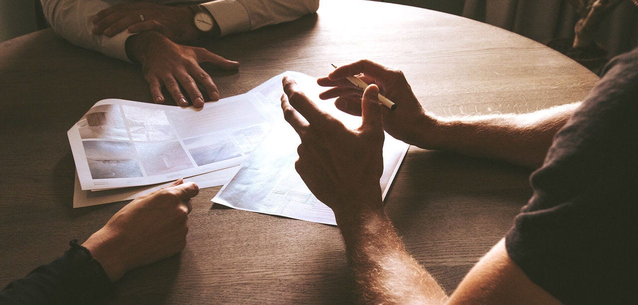 three pairs of hands on a table