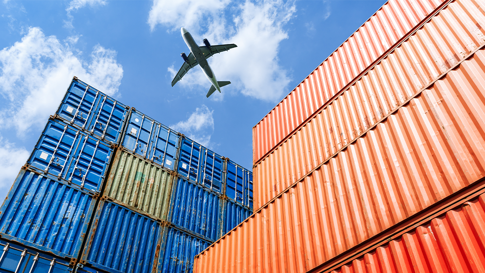 ground view of aeroplane over shipping containers
