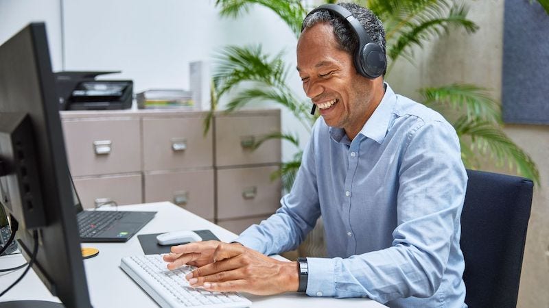 A customer service employee works while on the phone