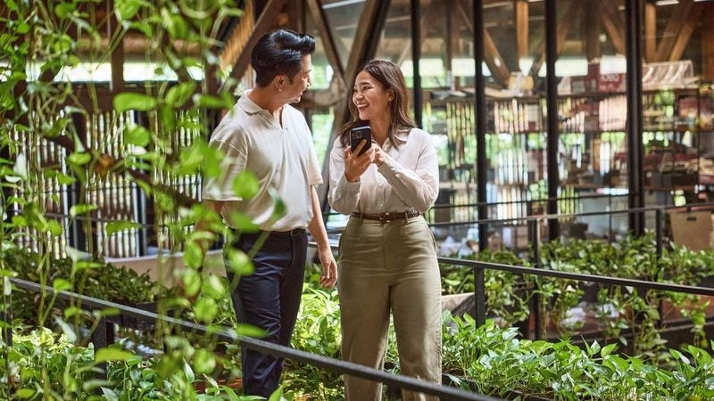two business owners discussing reporting details for their company’s scope 3 emissions