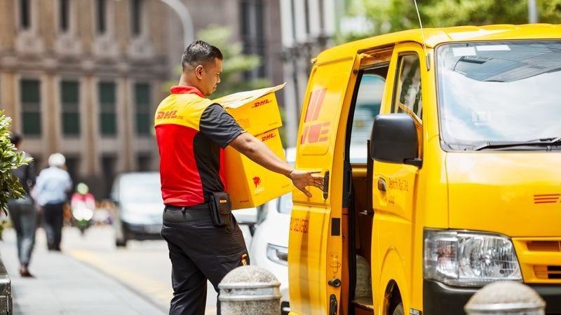 dhl courier loading up packages to van