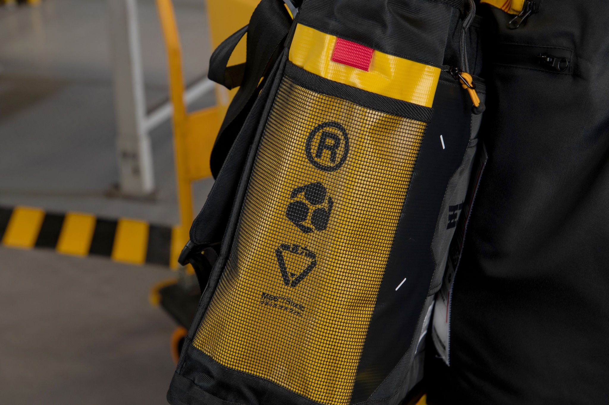 Side panel of a bag made from black mesh fabric 