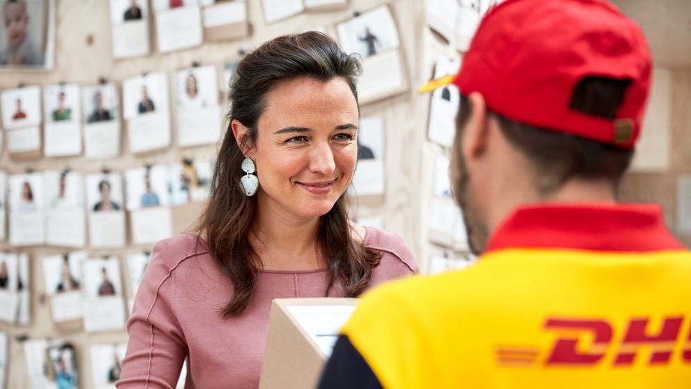woman from a small Indian business talking to a DHL employee