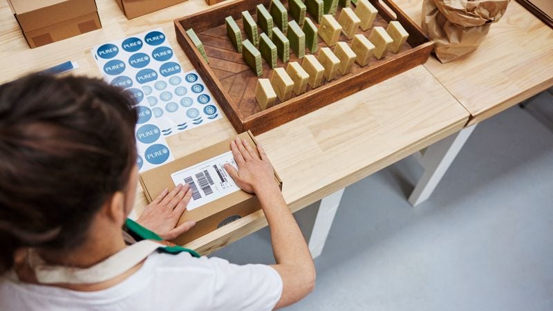 business owner packing sustainable products for shipping
