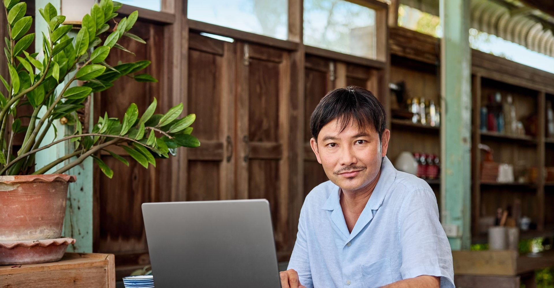 malaysian entrepreneur evaluating potential dropshipping suppliers on a laptop