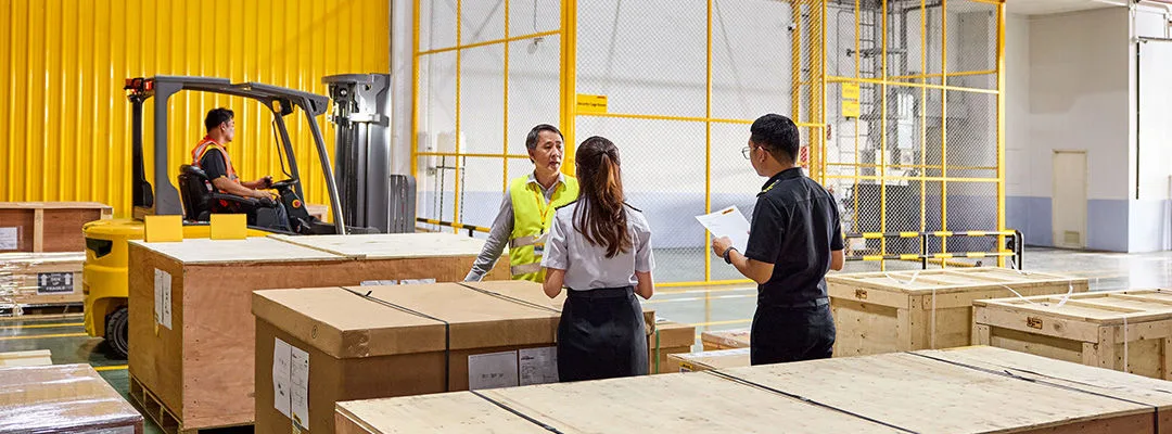 people in a warehouse with a man driving a forklift