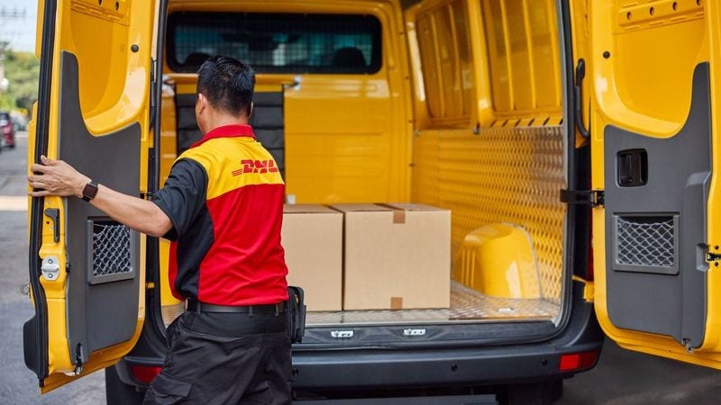 DHL personnel transporting goods for international shipping