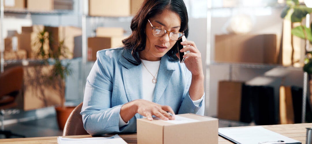 Woman reviewing shipping label on box