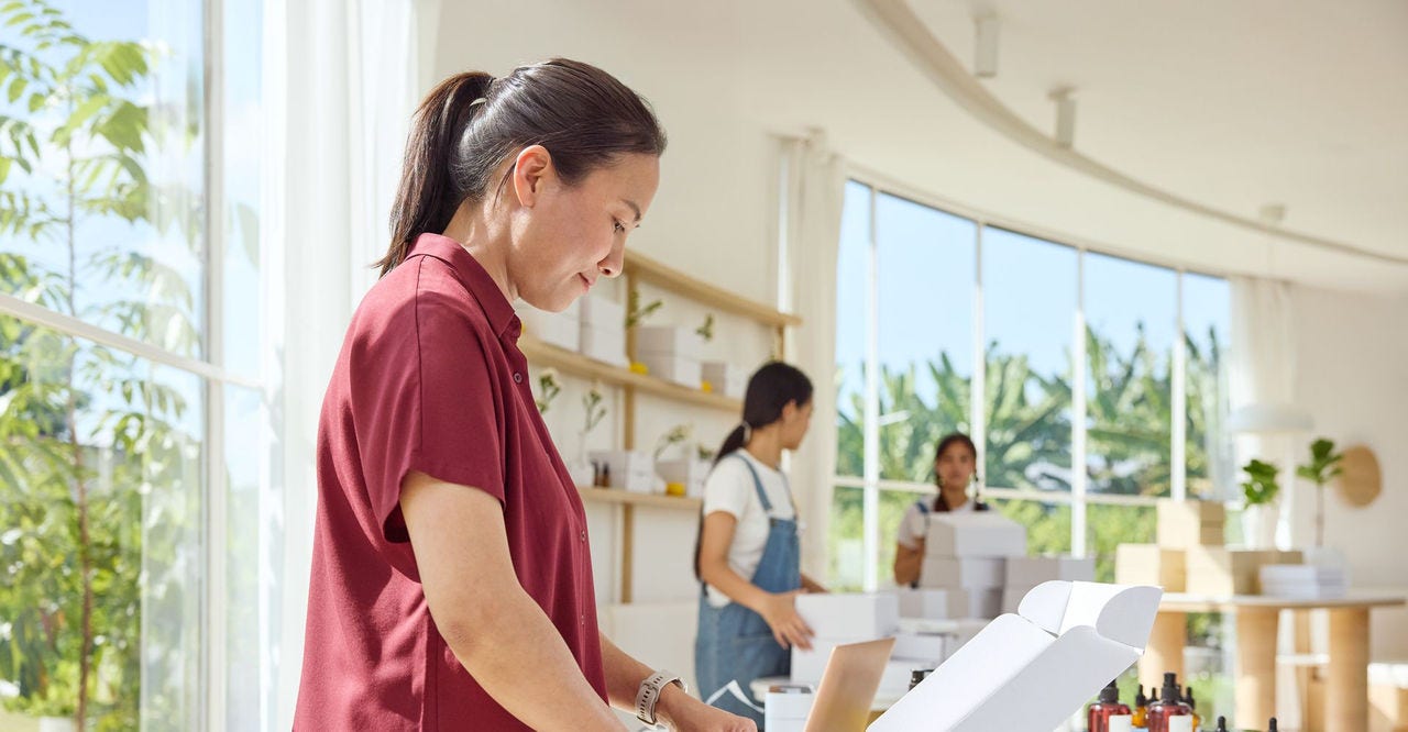 a japanese businesswoman packing products for export from japan