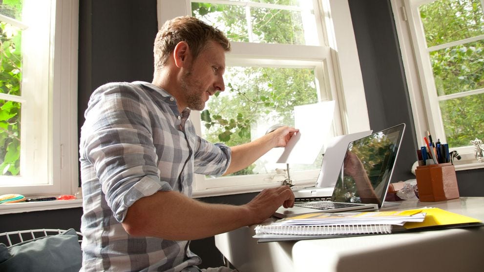 Entrepreneur working through documents in a home office while planning an import business