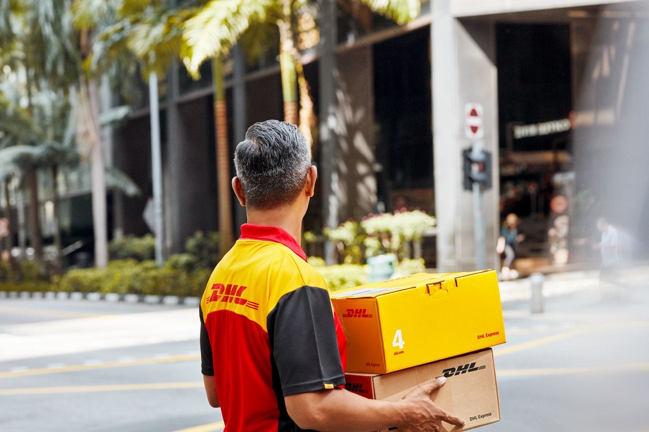 DHL parcel carrier crossing the street