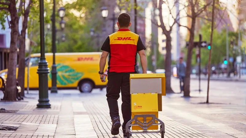 dhl express employee in china collecting parcels bound for pakistan