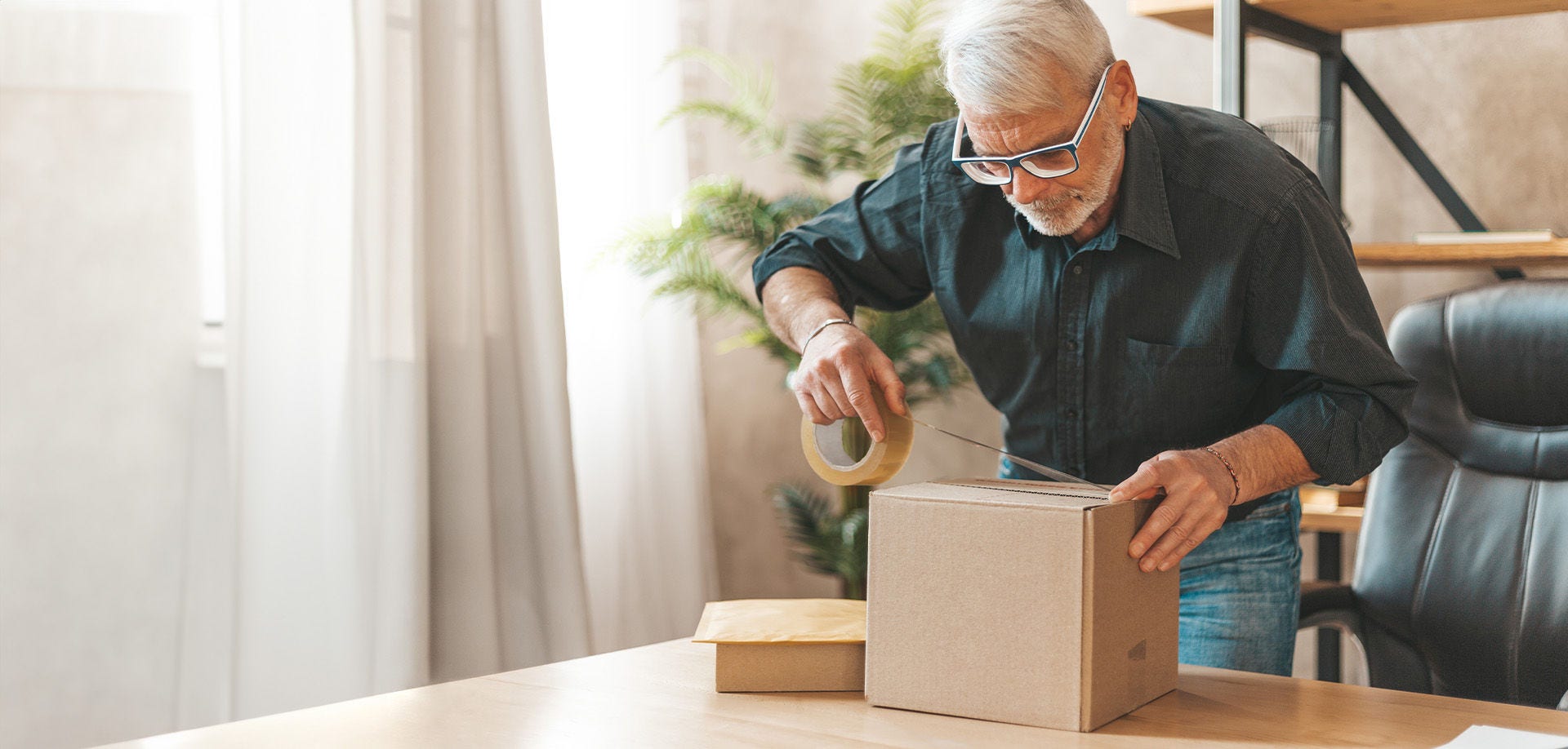 man wrapping parcel