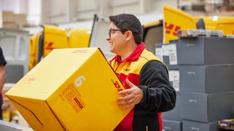 DHL Express employee lifting a parcel from a conveyor belt 