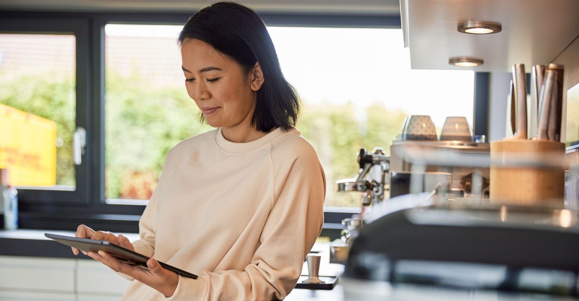 Seorang pemilik bisnis wanita menggunakan tablet untuk meneliti perjanjian perdagangan bebas di Indonesia