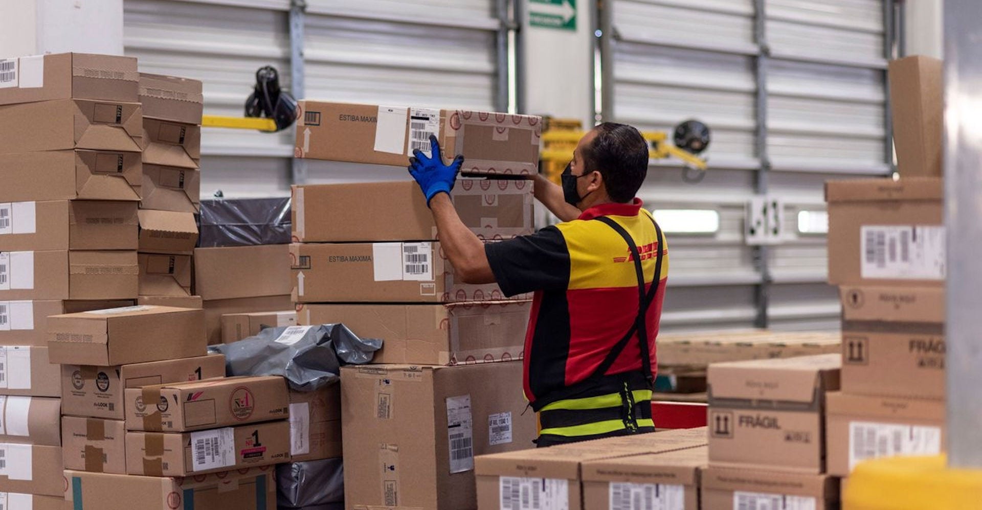 dhl express courier handing off a package to a happy customer