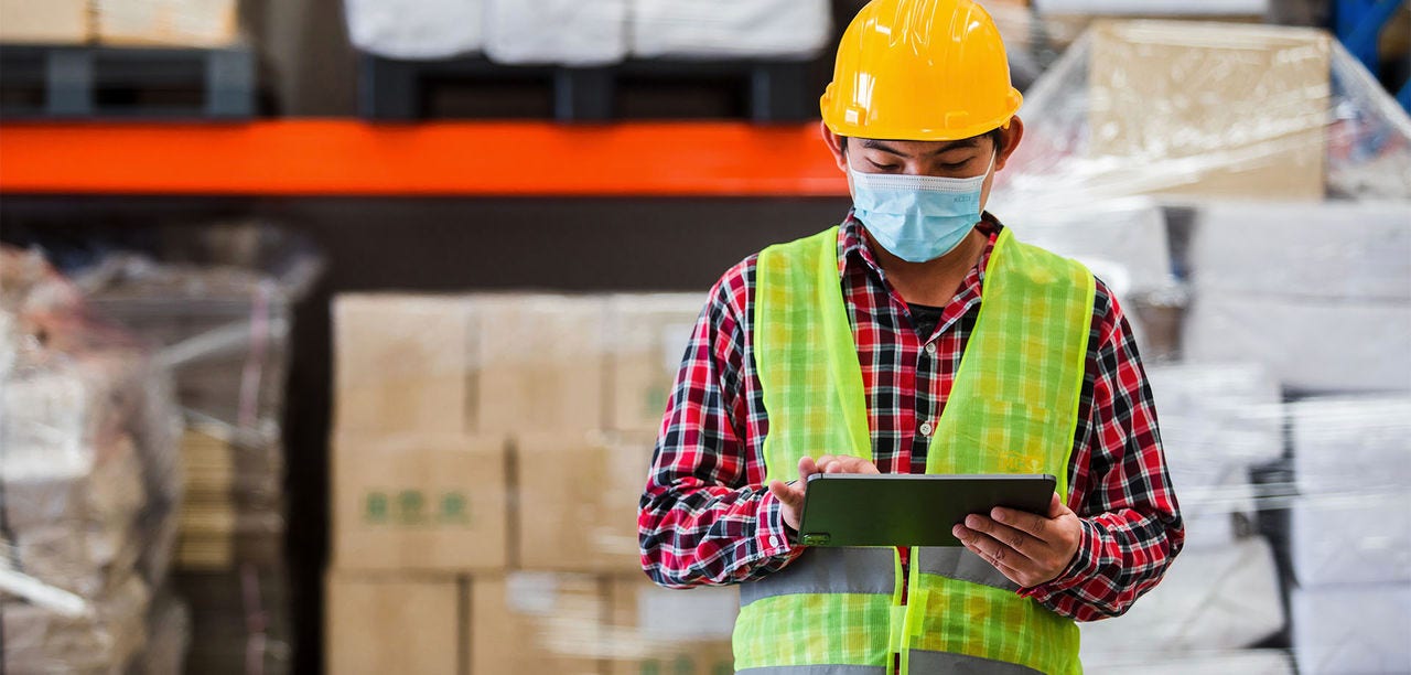 warehouse worker looking at a tablet