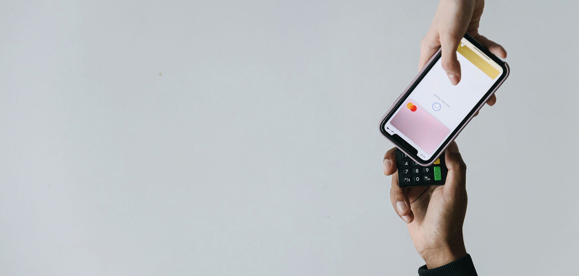 hands holding a mobile phone and card