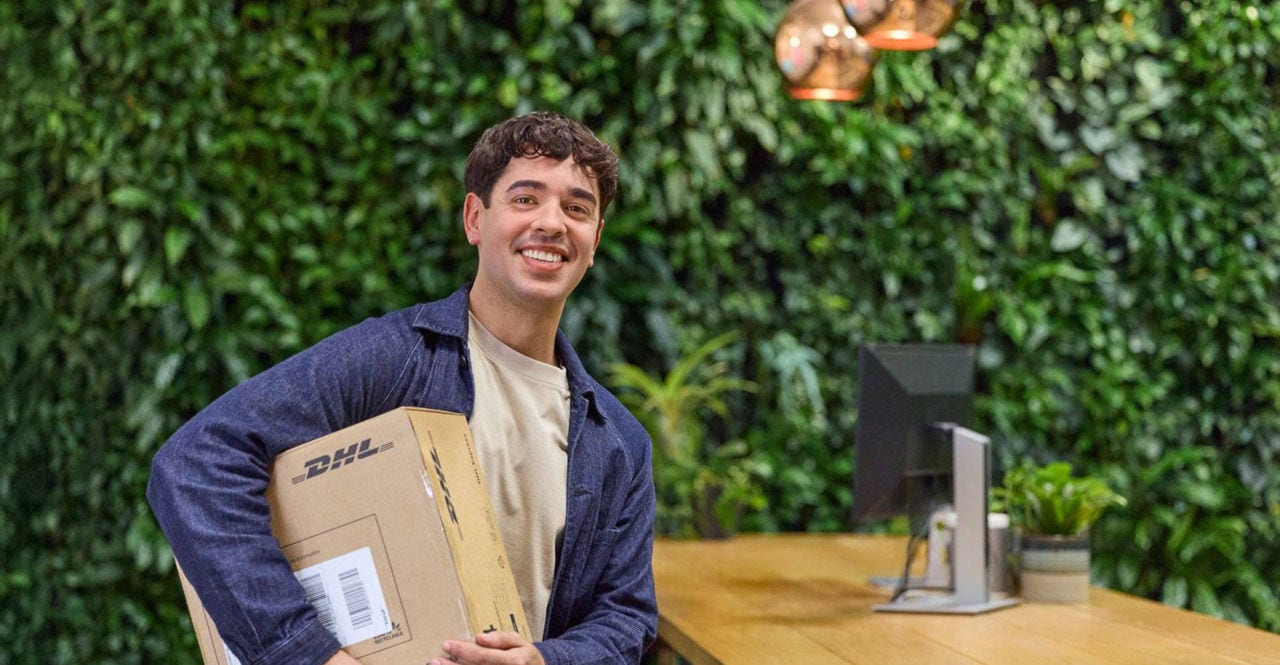 person carrying a dhl parcel