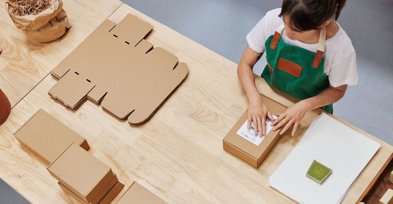 store owner packaging goods for express delivery to customers