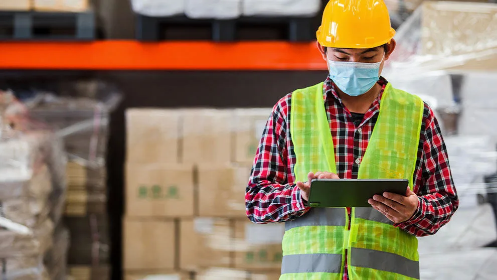 warehouse worker looking at a tablet