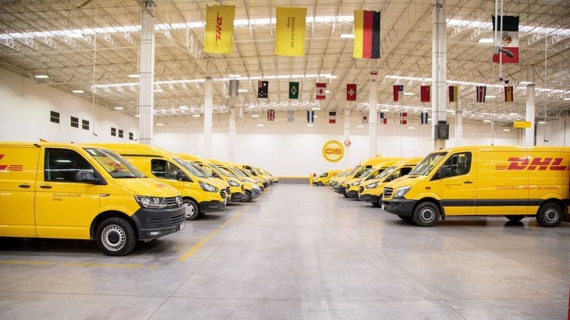 DHL Express vans parked in a depot