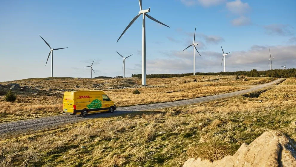 dhl-electric-delivery-van-driving-through-windmill-park