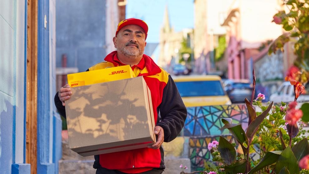 dhl employee delivering parcels during peal season sales