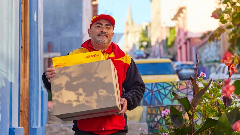 dhl employee delivering parcels during peal season sales